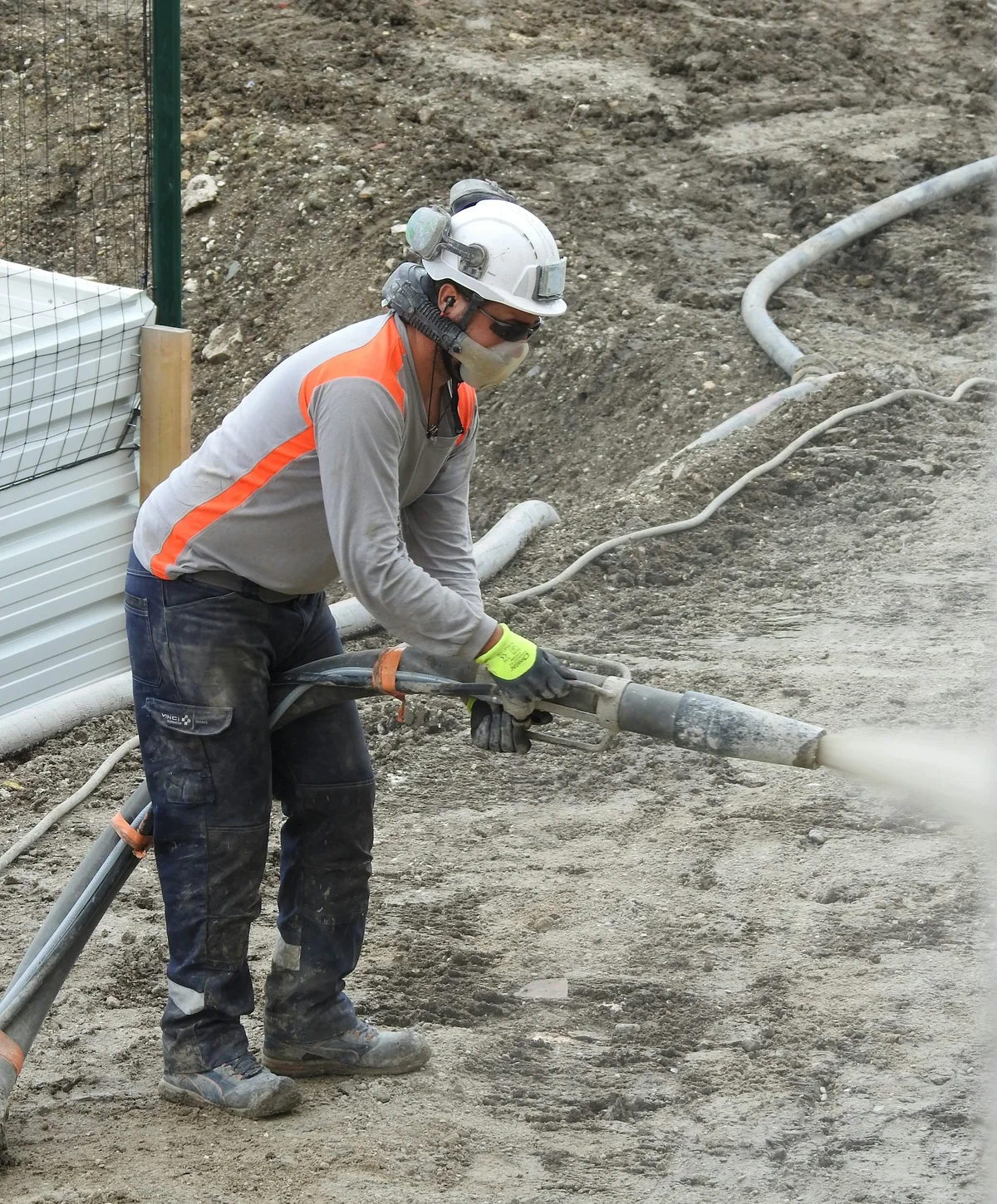 Industrial worker wearing hard hat, eye protection and respiratory PPE